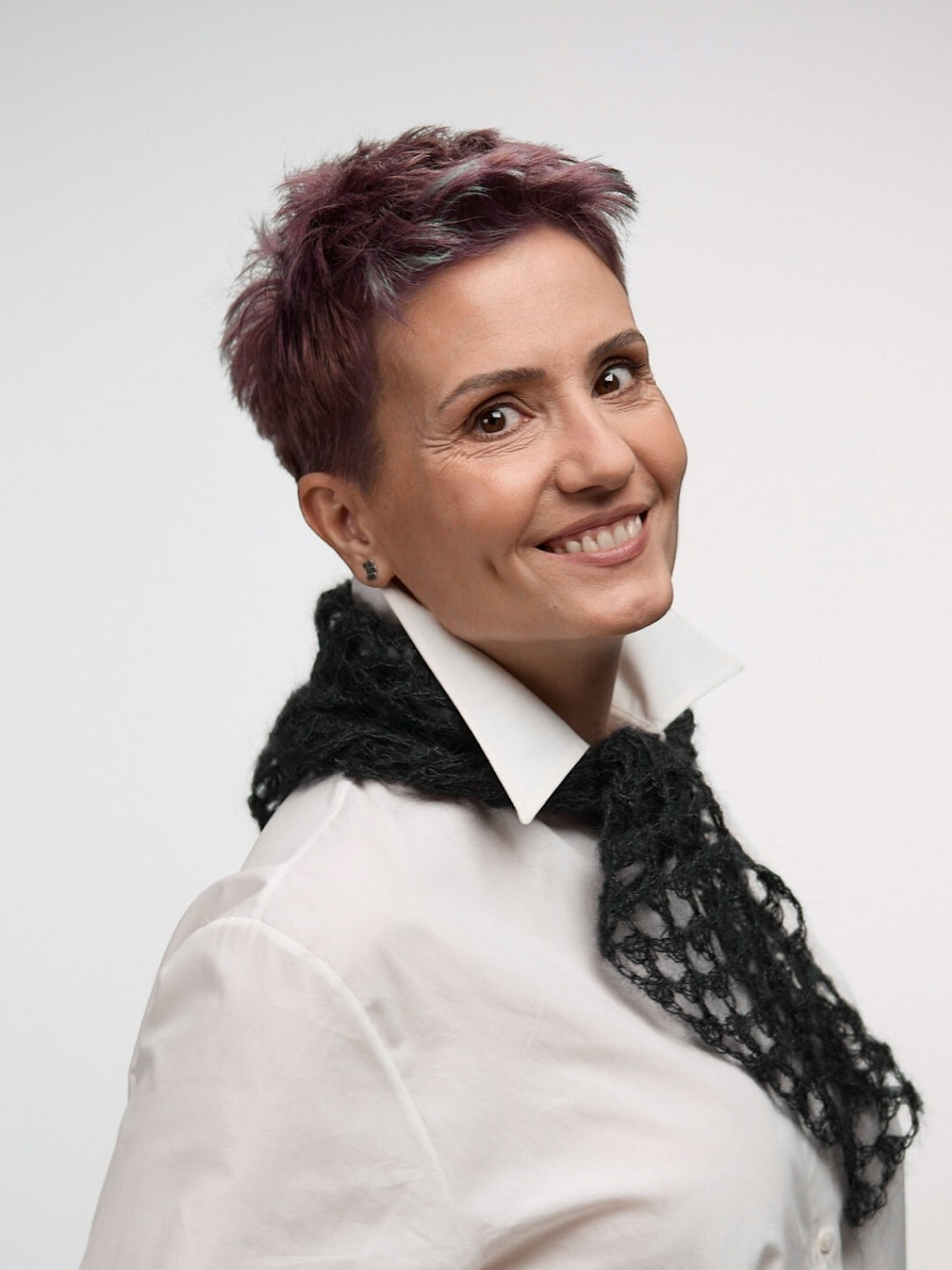 Ipanomi black hand-crocheted scarf made from alpaca and silk, featuring an open-knit pattern.