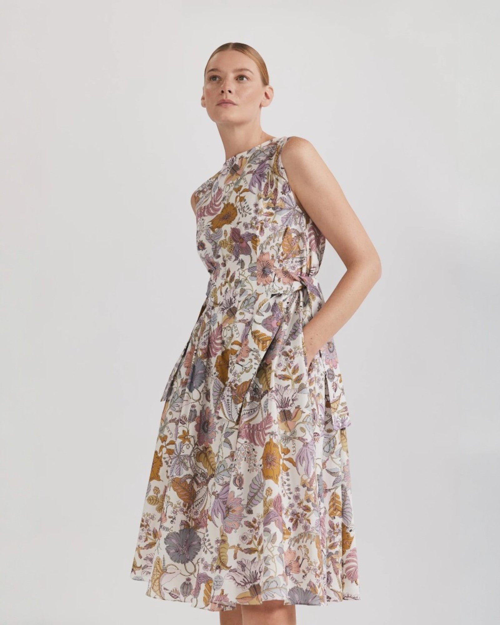 Ipanomi midi dress in Tana Lawn cotton with a floral print, sleeveless, with pockets and a tie waist.