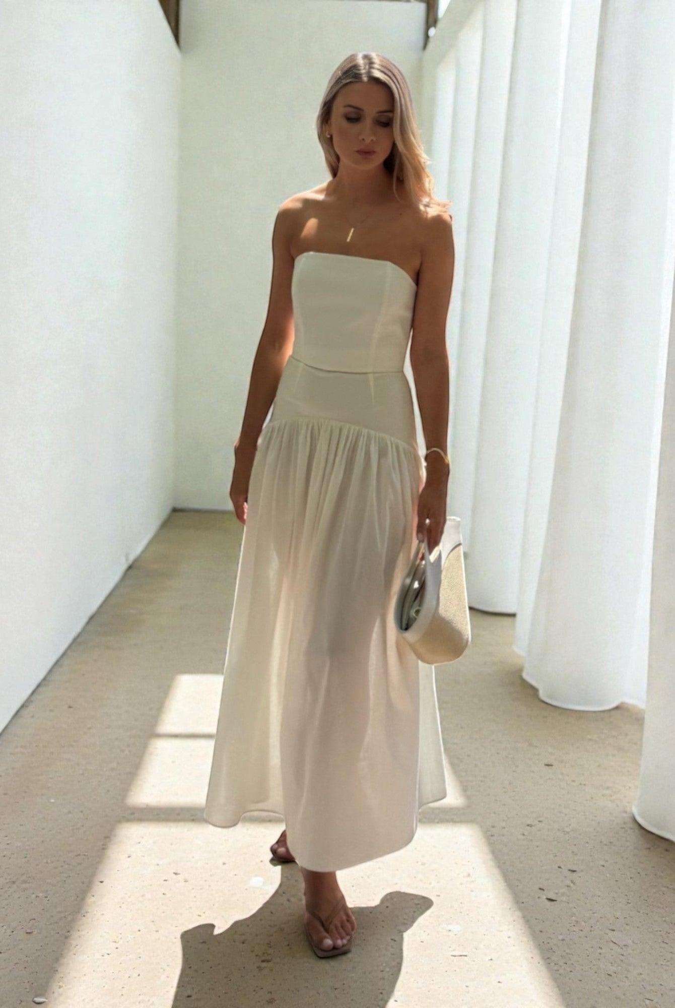 Ipanomi white cotton poplin corset and maxi skirt set on a woman. The set is versatile and can be worn together or separately.