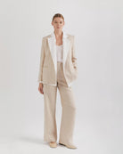 Ipanomi beige linen blazer with white contrast lapels, no buttons, and a feminine cut. Features cotton lining and long sleeves.