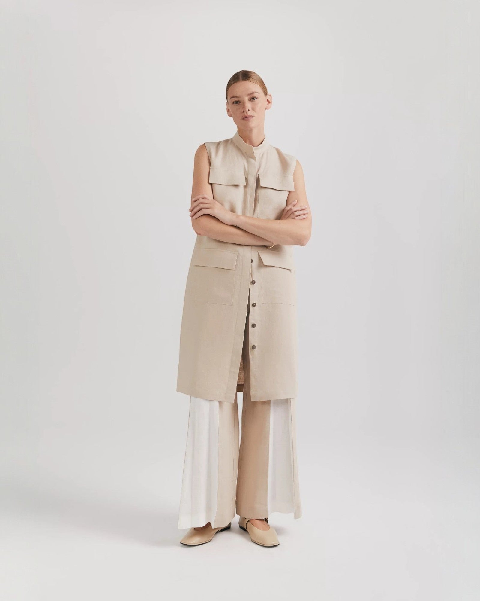 Ipanomi beige linen midi dress with mandarin collar, button front, patch pockets, and sleeveless design. Versatile cargo style.