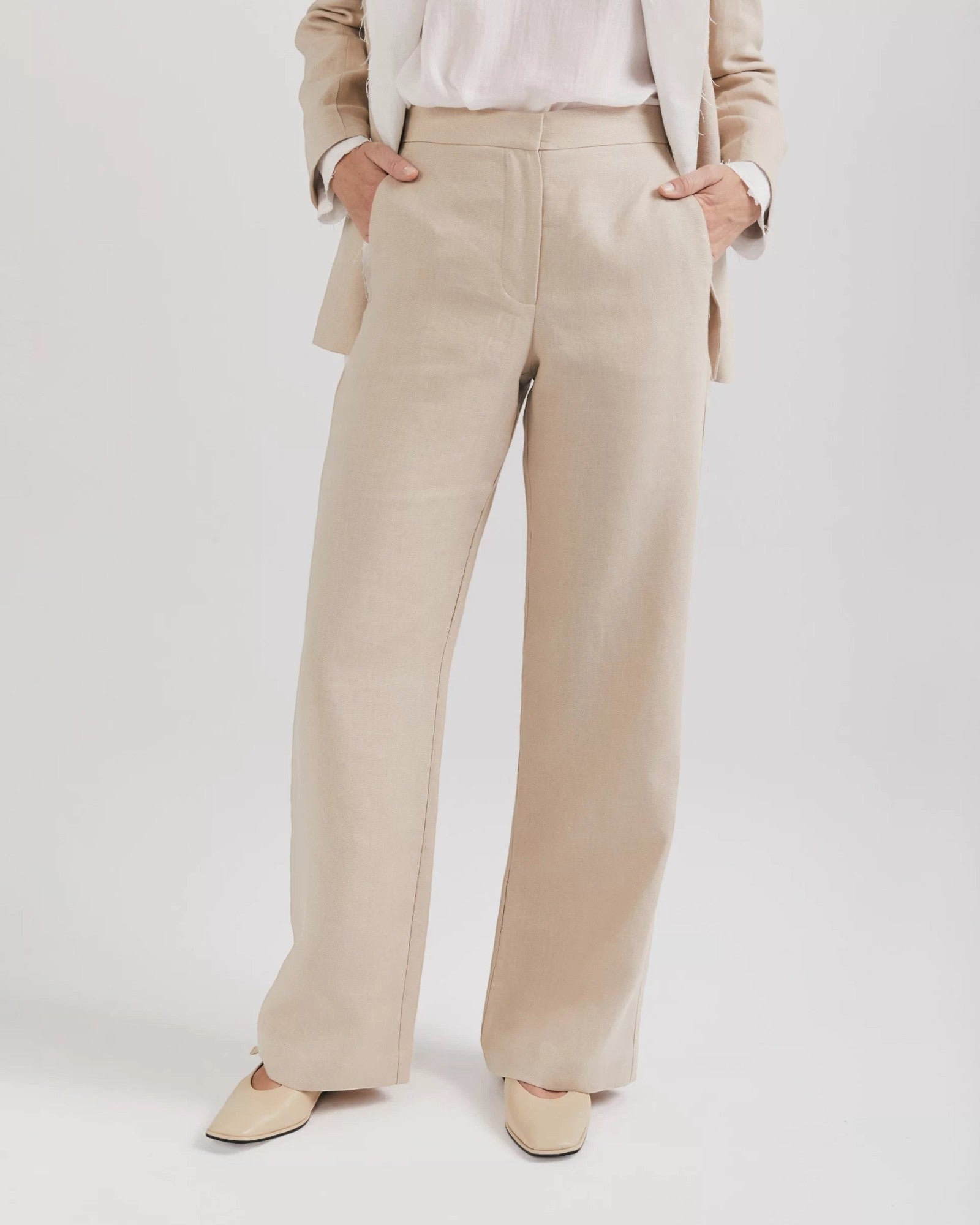 Ipanomi beige 100% linen wide-leg trousers with high waist and side pockets. Elegant OEKO-TEX certified.