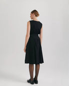 Ipanomi black organic cotton midi dress with pleats, hidden pockets, and a flared skirt.