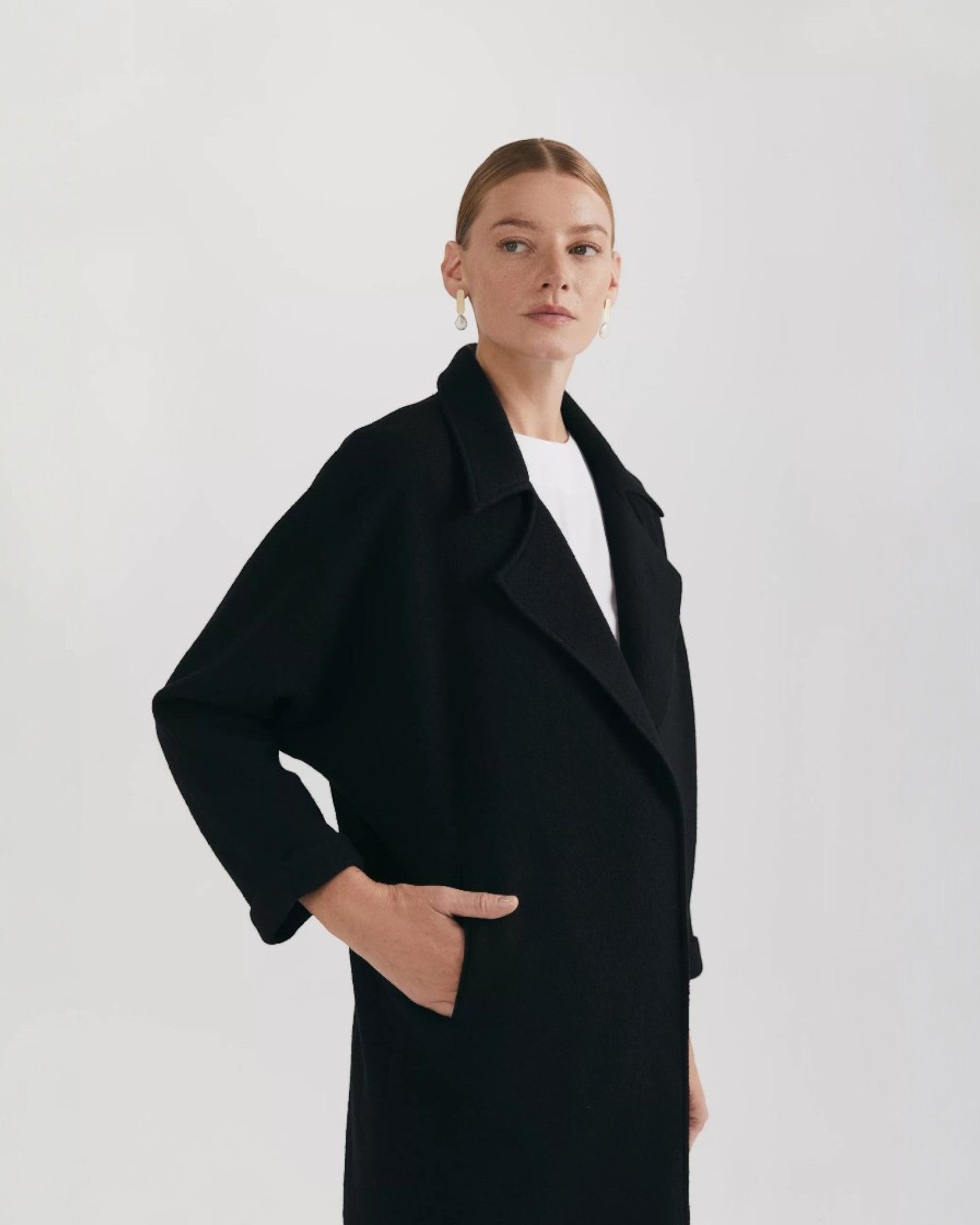 Ipanomi black oversized wool coat with scarf collar and invisible snap closure. Side pockets.