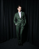 Ipanomi elegant fitted green Italian wool suit with a classic collar and button closure. Model wears a white shirt.