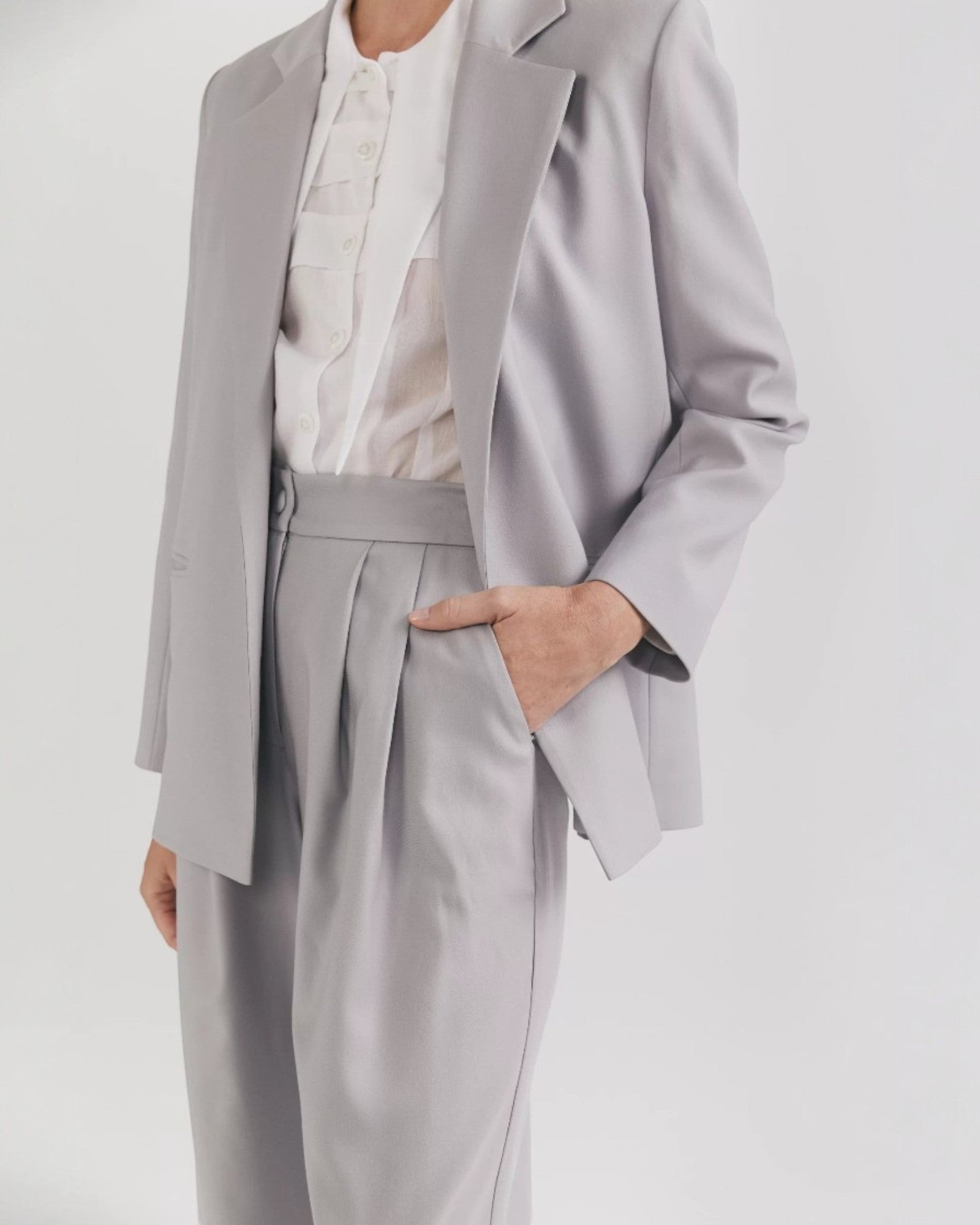 Ipanomi grey premium wool palazzo pants with double pleats, side pockets, and a covered button closure.