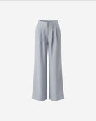 Ipanomi light blue pure linen wide-leg trousers with double pleats and high waist. Model wearing size S.