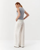 Ipanomi light blue pure linen sleeveless vest with V-neck and contrast buttons. Model wears size S.