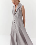Ipanomi light grey organic cotton maxi dress with collar, button front, and hidden pockets. Sleeveless A-line design.