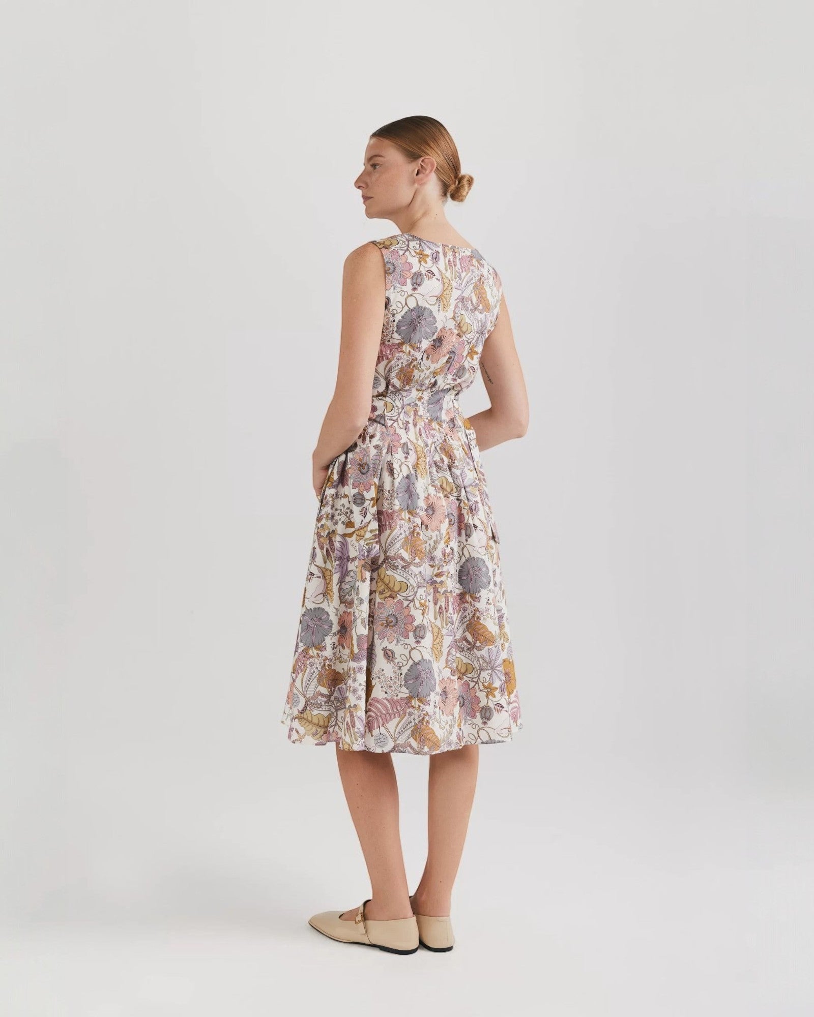 Ipanomi midi dress in Tana Lawn cotton with a floral print, sleeveless, flared skirt, and side pockets.
