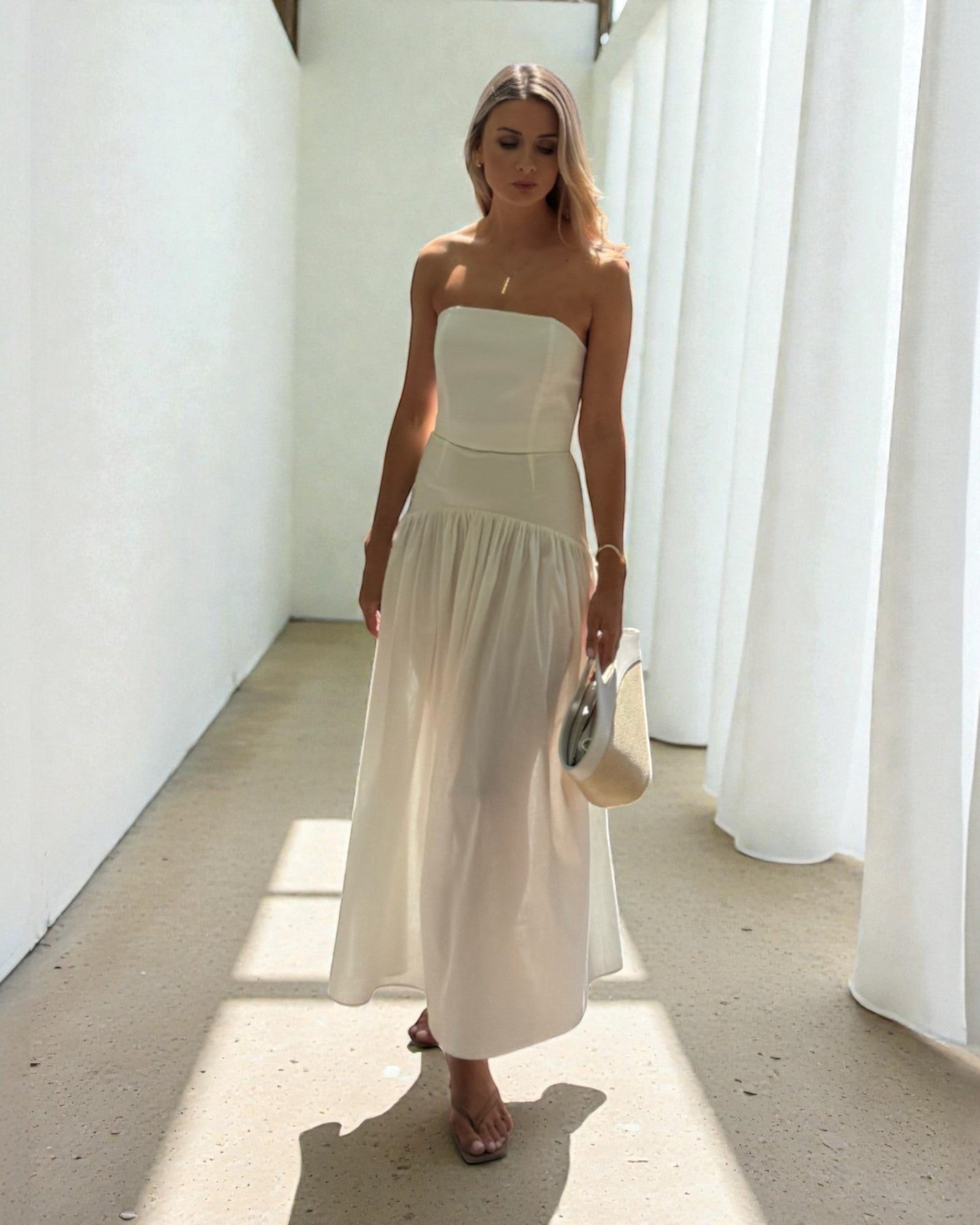Ipanomi white cotton poplin corset and maxi skirt set on a woman. The set is versatile and can be worn together or separately.