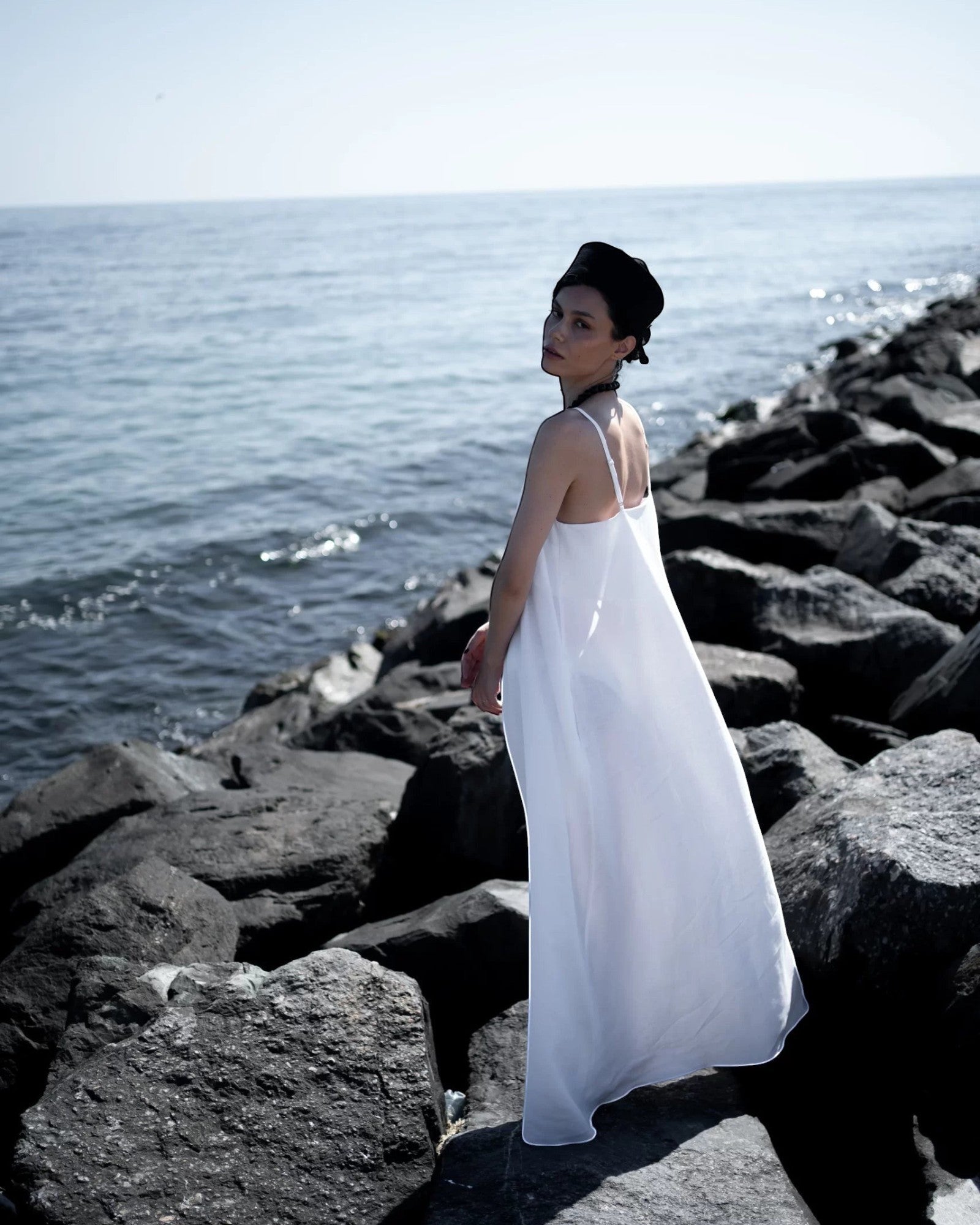 Ipanomi white hemp maxi dress with adjustable straps and A-line cut, perfect for warm days or special occasions.