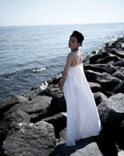 Ipanomi white hemp maxi dress with adjustable straps and A-line cut, perfect for warm days or special occasions.