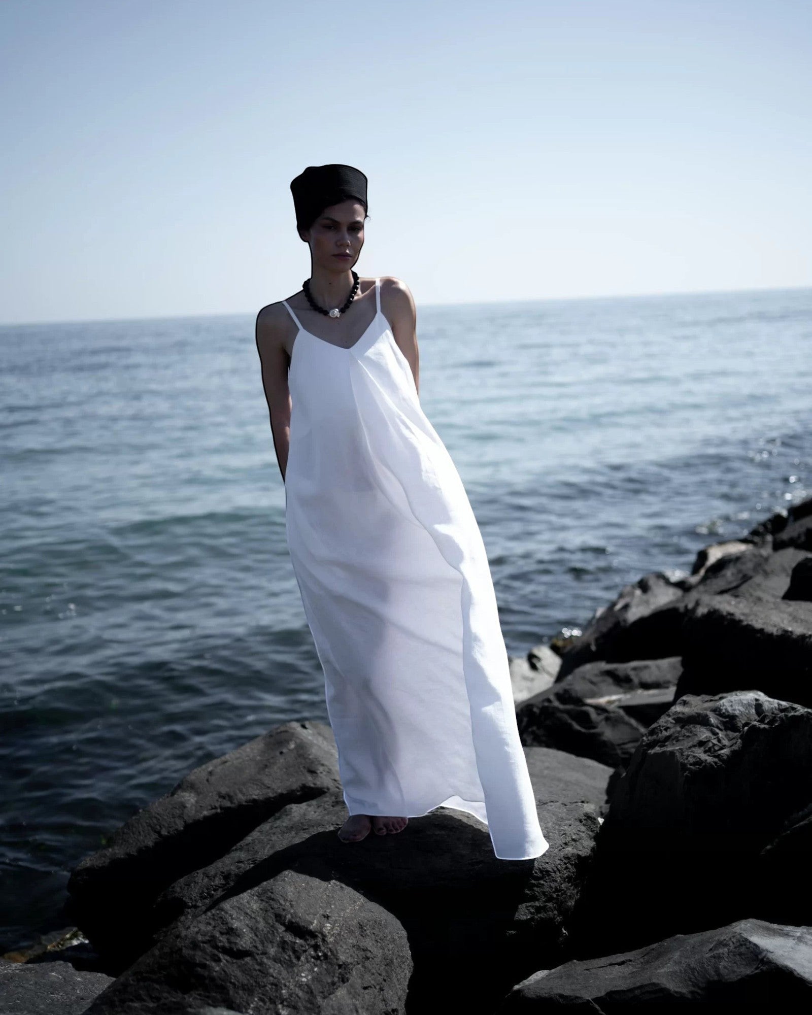 Ipanomi white hemp maxi dress with adjustable straps and A-line cut, perfect for summer.