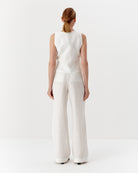 Ipanomi white hemp wide-leg trousers with double pleats and back pockets. Model wears size S.