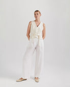 Ipanomi white linen wide-leg trousers with double pleats, side slant pockets, back pockets, and zip closure.
