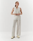 Ipanomi white linen trousers with black pinstripes, high-waisted, straight leg, and side pockets.